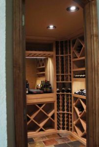 Peer into this small wine room from its arched wine cellar door.