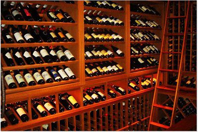 Custom built home wine cellar with full height ladder system, custom racking, bins